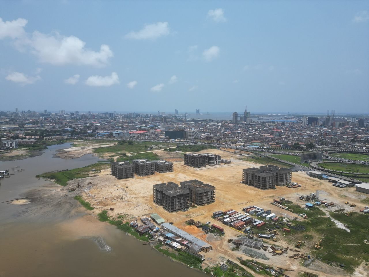Aerial view of a large waterfront development and active construction site